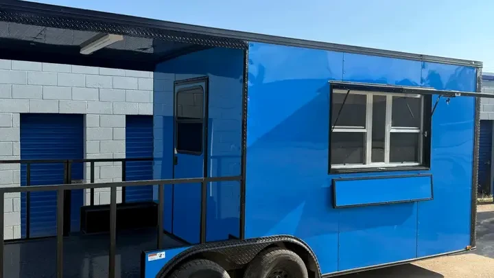 Blue BJP food and concession trailer with a serving window and exterior porch